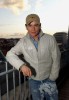 Stephen Gately photo wearing a gray rain jacket and dark denim pants