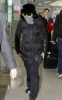 Madonna arrives at Heathrow International Airport in London on January 26th 2010 while covering her face with a checkered scarf 2