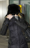 Madonna arrives at Heathrow International Airport in London on January 26th 2010 while covering her face with a checkered scarf 4