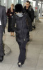 Madonna arrives at Heathrow International Airport in London on January 26th 2010 while covering her face with a checkered scarf 3