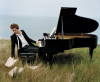 Robert Pattinson photo shoot of December 2009 issue of Vanity Fair Magazine beside a piano in an open field 2