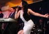 haifa Wehbe photo while singing on stage during her USA tour concert in March 2010 wearing a double white and black dress 2