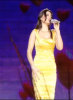 Haifa Wehbe singing on stage wearing a stylish yellow dress 1