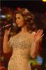 Singer Mai Selime sings on stage at the TV musical show The Stage AL Haflah in April 2010 wearing a shiny beige dress 3