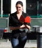 Taylor Cole candid picture while spotted walking the street recently wearing long black boots over denim trousers and a black shirt 3