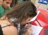 Layan Bazlamit picture on July 3rd 2011 as she arrives to Amman airport in Jordan signing an autograph for a fan